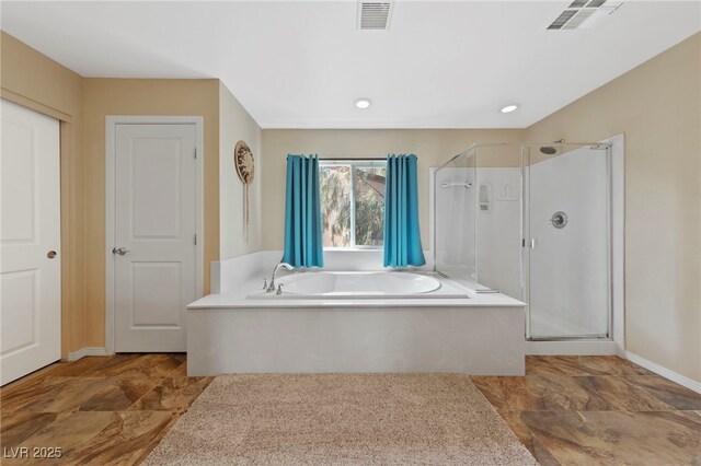 bathroom with shower with separate bathtub