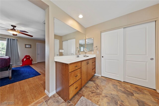 bathroom featuring ceiling fan and vanity