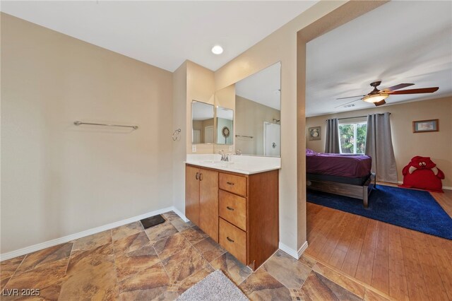 bathroom featuring ceiling fan and vanity