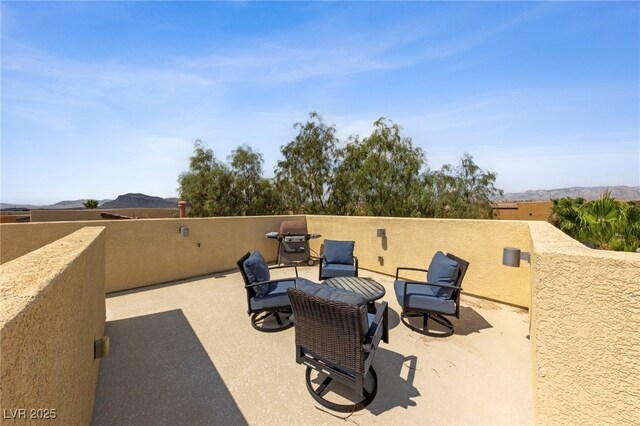 view of patio / terrace featuring a mountain view