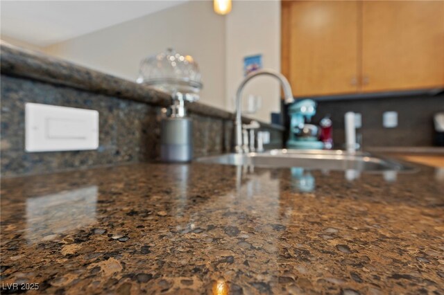 details with sink and dark stone countertops