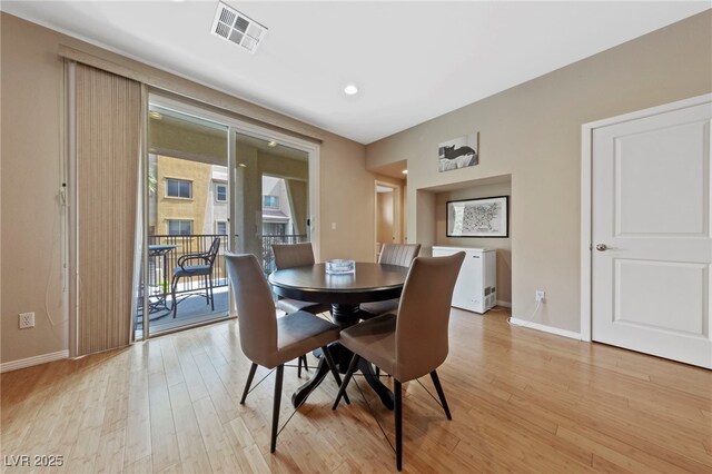 dining area with a healthy amount of sunlight and light hardwood / wood-style flooring