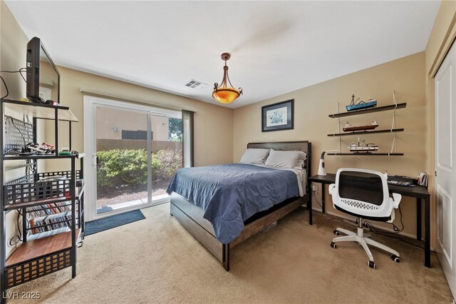 carpeted bedroom featuring a closet and access to exterior