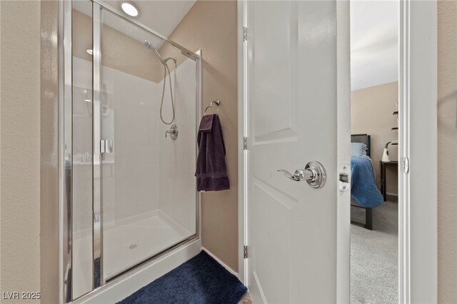 bathroom with a shower with door