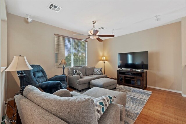 living room featuring light wood-type flooring and ceiling fan