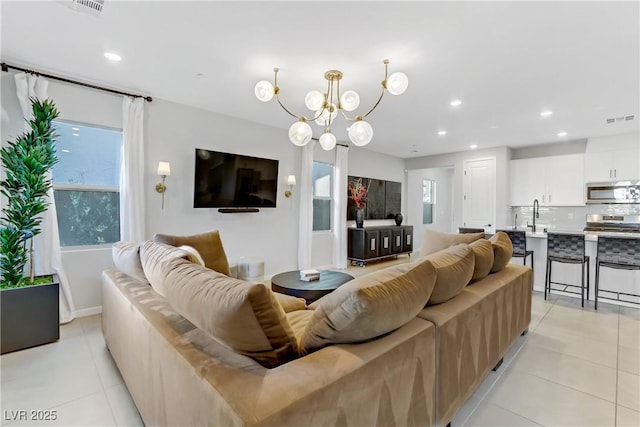 tiled living room with sink and a chandelier