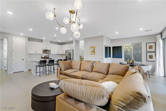 tiled living room featuring a chandelier