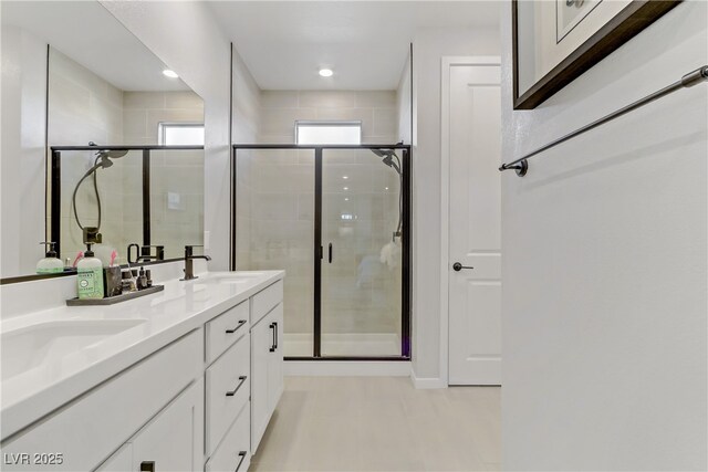 bathroom featuring walk in shower and vanity