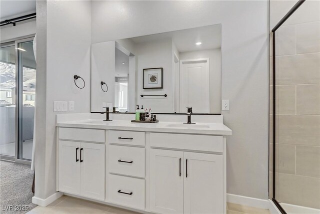 bathroom with a shower with door and vanity