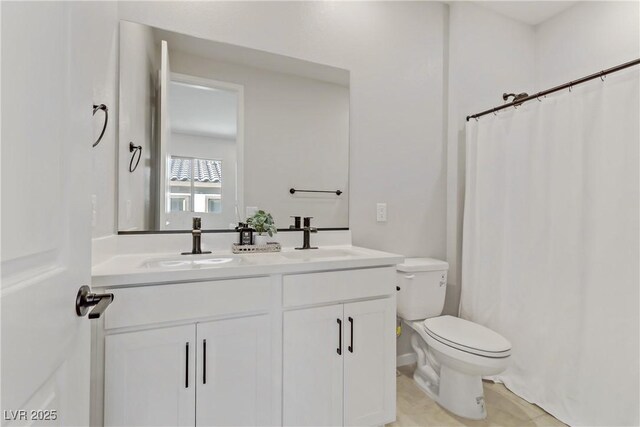 bathroom with toilet, vanity, and tile patterned flooring