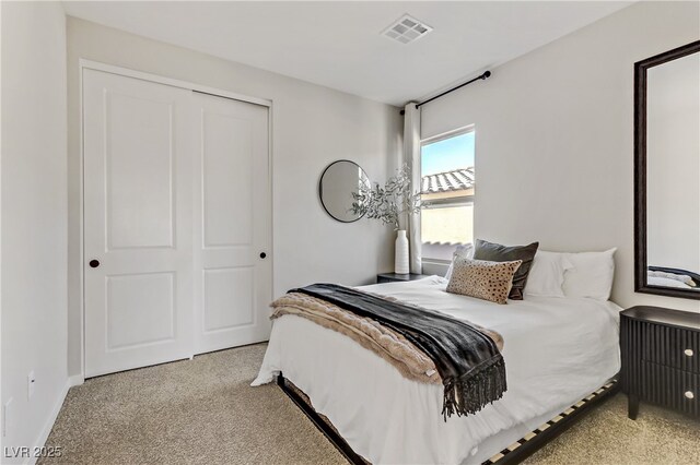 bedroom with radiator heating unit, a closet, and light colored carpet