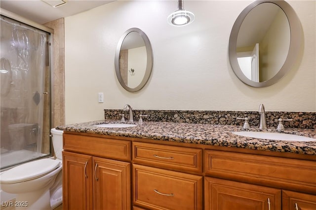 full bathroom with toilet, vanity, and enclosed tub / shower combo