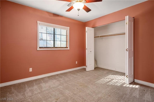 unfurnished bedroom featuring ceiling fan, a closet, and light carpet