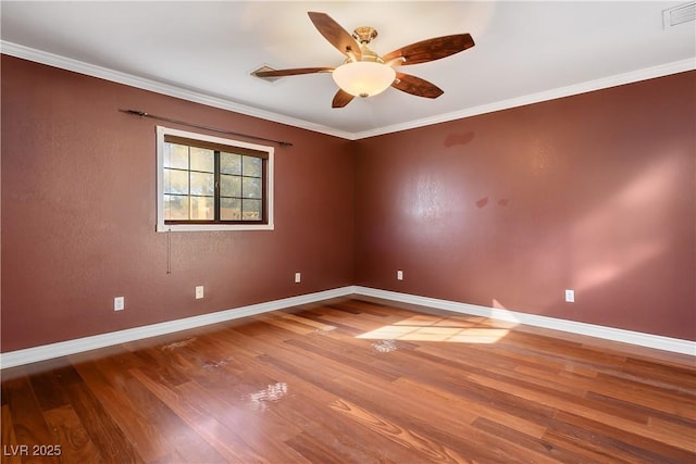 empty room featuring ceiling fan, crown molding, and hardwood / wood-style flooring