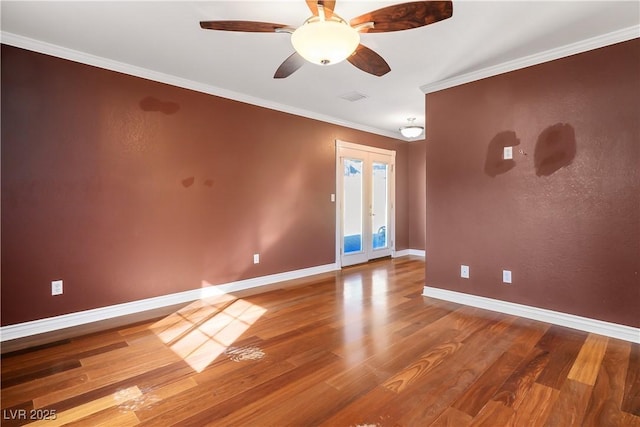 spare room with hardwood / wood-style flooring, french doors, ceiling fan, and crown molding