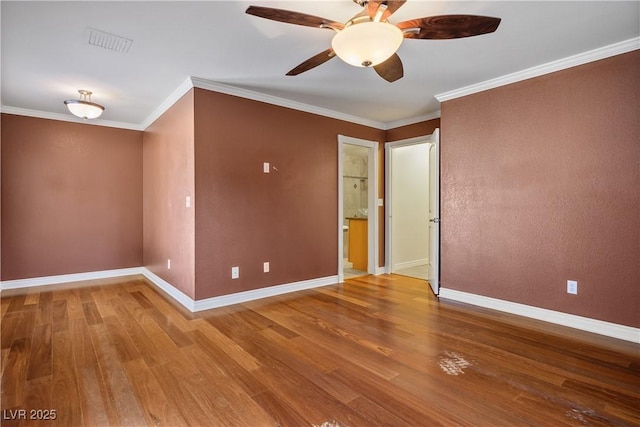 empty room featuring ornamental molding, ceiling fan, and hardwood / wood-style floors