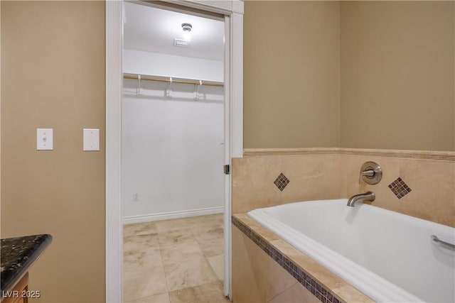 bathroom featuring tile patterned floors and tiled bath