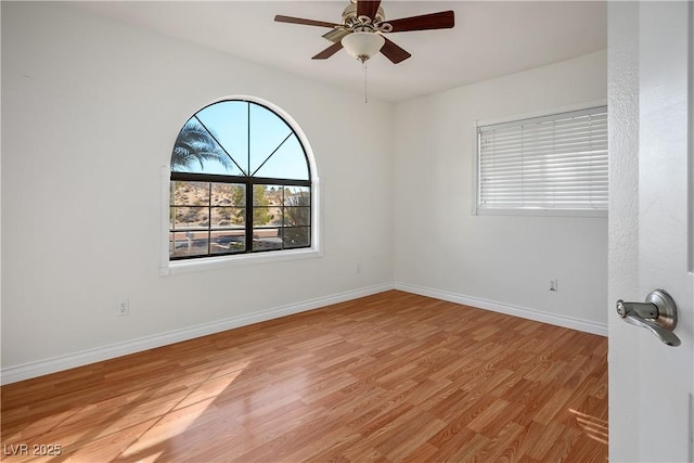 spare room with light wood-type flooring and ceiling fan