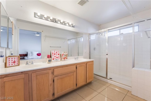 bathroom with vanity, tile patterned flooring, and a shower with shower door