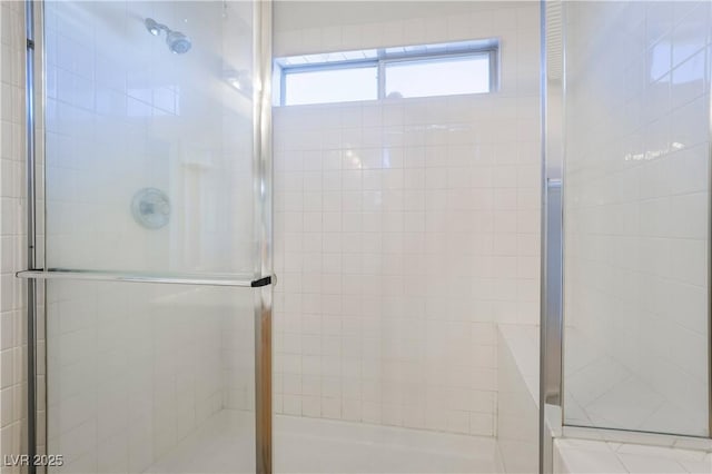 bathroom with a shower with door