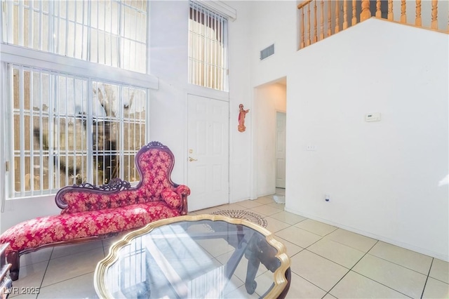 interior space with a towering ceiling and tile patterned floors