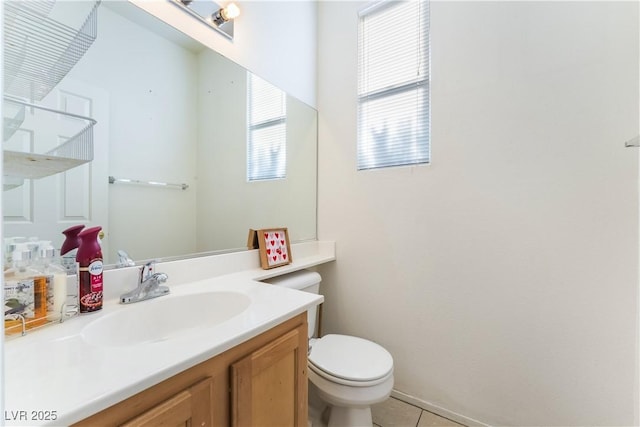 bathroom with tile patterned flooring, vanity, and toilet