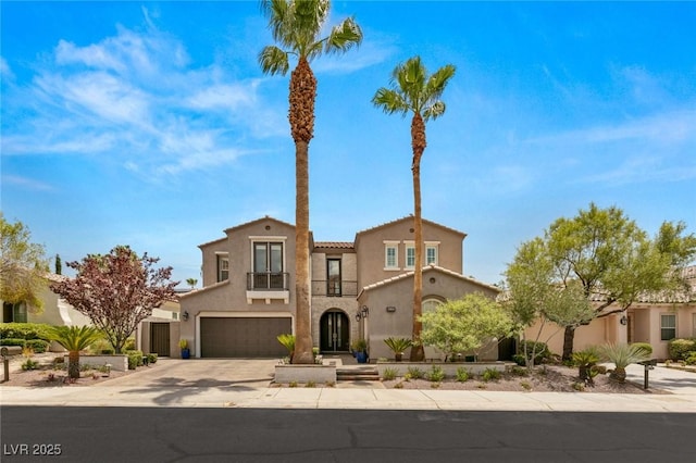 mediterranean / spanish-style home with a garage