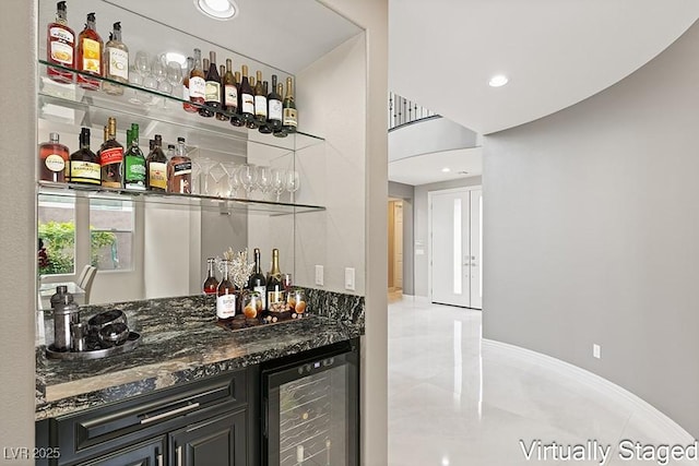 bar with dark stone counters and beverage cooler