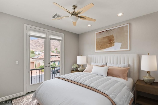 bedroom featuring access to outside, ceiling fan, and multiple windows