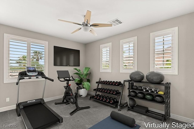 workout area featuring ceiling fan and carpet