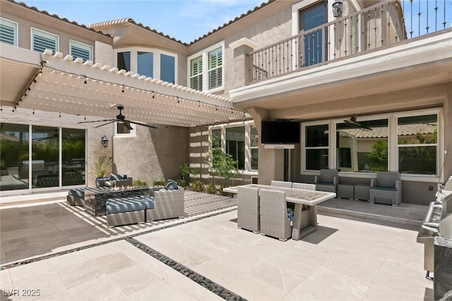 view of patio / terrace with a balcony, ceiling fan, outdoor lounge area, and a pergola