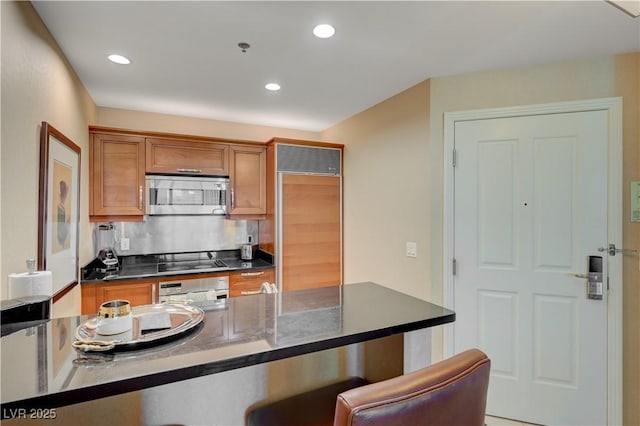 kitchen with stainless steel appliances and decorative backsplash