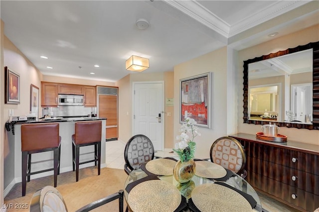 tiled dining space featuring ornamental molding