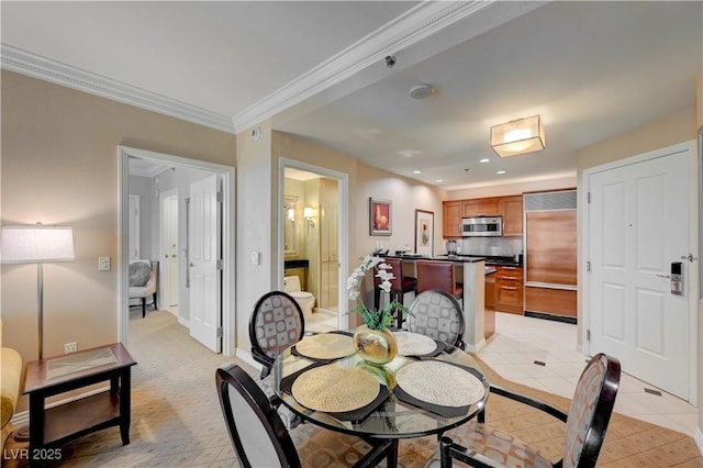 dining area with light tile patterned flooring and crown molding