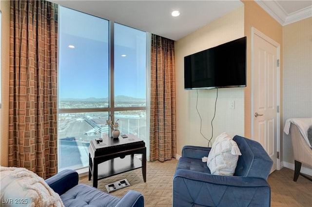 living room with ornamental molding and expansive windows