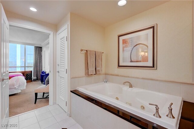 bathroom with tiled tub and tile patterned floors