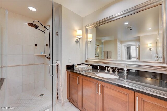 bathroom featuring walk in shower, vanity, and tile patterned floors