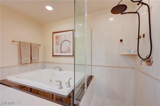 bathroom featuring shower with separate bathtub