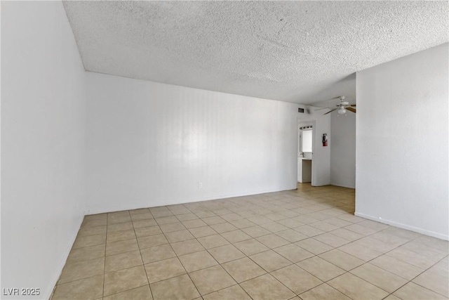 tiled empty room with a textured ceiling and ceiling fan