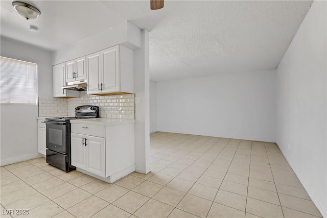 kitchen featuring light tile patterned floors, white cabinetry, tasteful backsplash, and black electric range oven