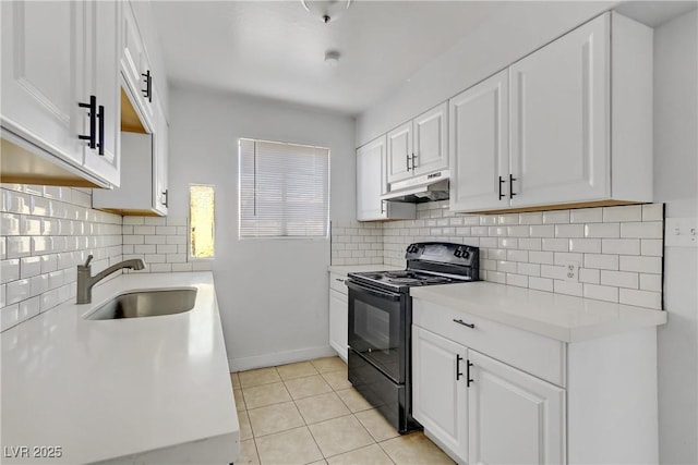 kitchen with white cabinets, black electric range oven, light tile patterned floors, decorative backsplash, and sink