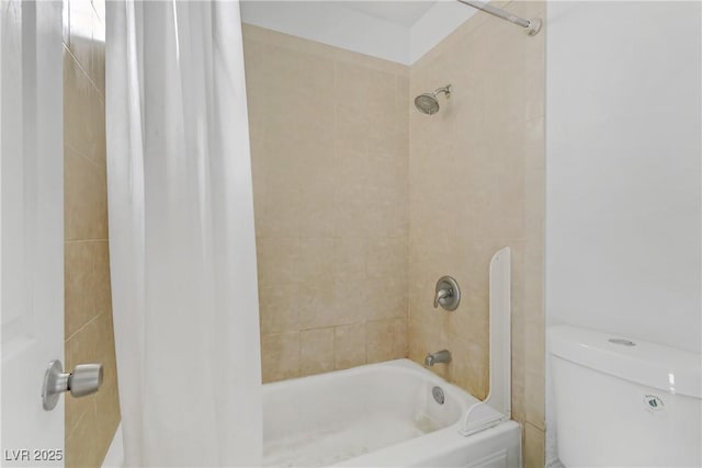 bathroom with toilet and tiled shower / bath combo