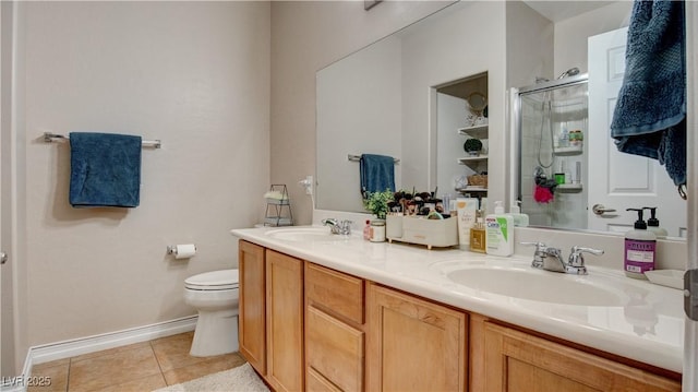 bathroom with toilet, a shower with door, vanity, and tile patterned floors