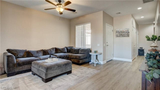 living room featuring ceiling fan and light hardwood / wood-style flooring