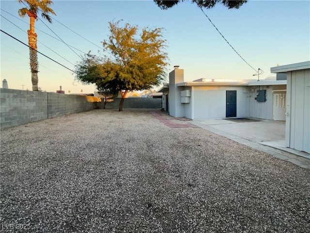 yard at dusk featuring a patio