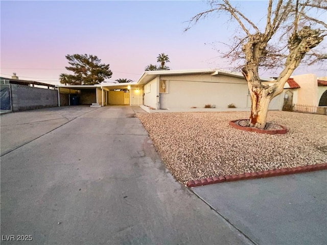 single story home featuring a carport