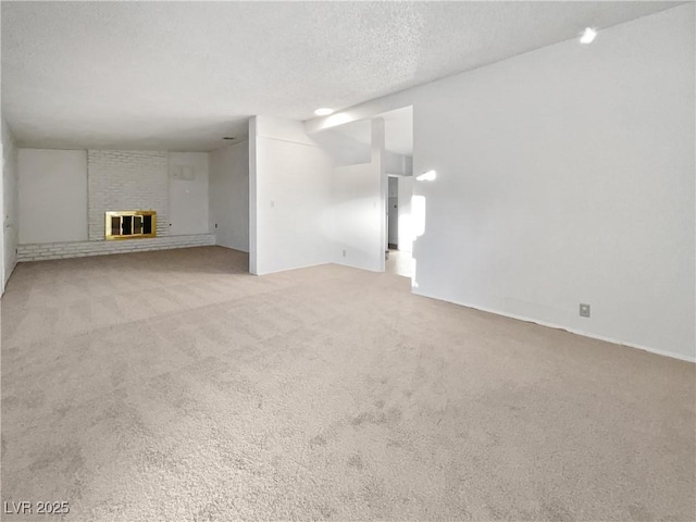 unfurnished living room with a textured ceiling, vaulted ceiling, light carpet, and a fireplace