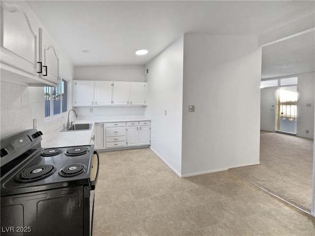 kitchen featuring white cabinets, black range with electric cooktop, and sink