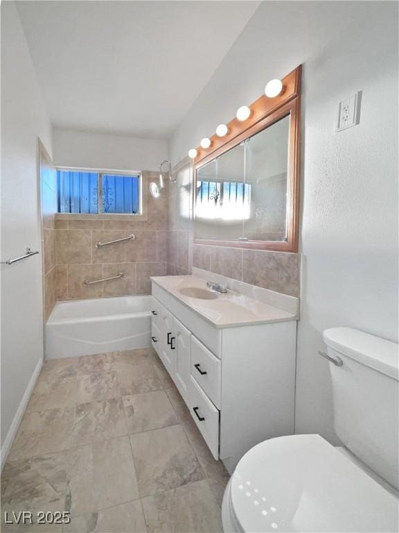 full bathroom with toilet, vanity, and tiled shower / bath