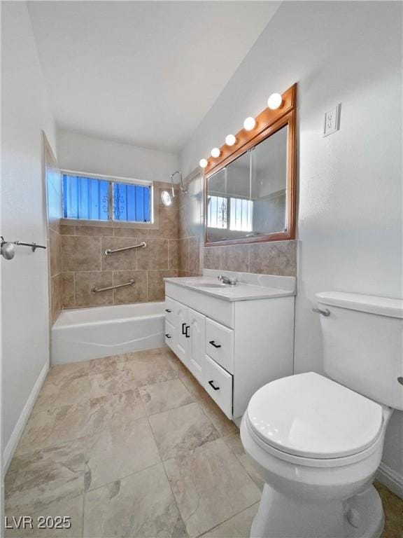 full bathroom featuring toilet, vanity, and tiled shower / bath